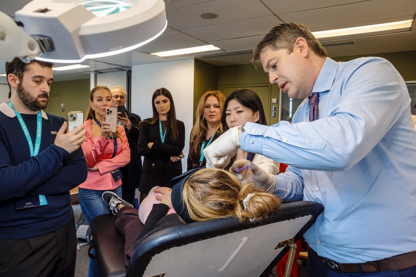 Participating physicians gathered around a live demonstration at a workshop
